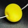 Große handgefertigte Lampwork-Glasperle in Zitronengelb als Wechselperle auf einem Edelstahl-Halsreif.